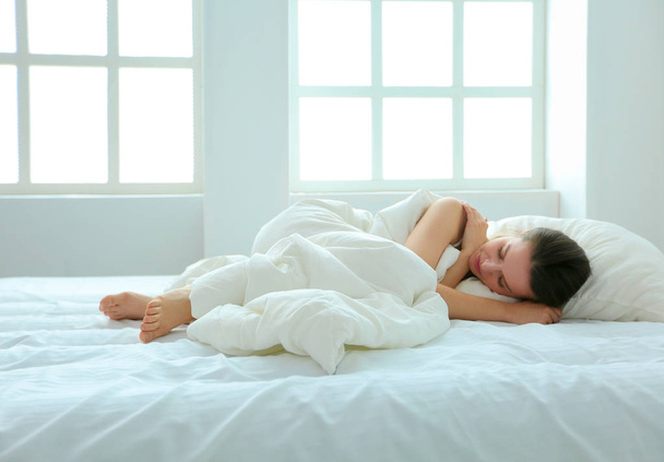 Young female feeling pain in bed. - Fotografie, Obrázek