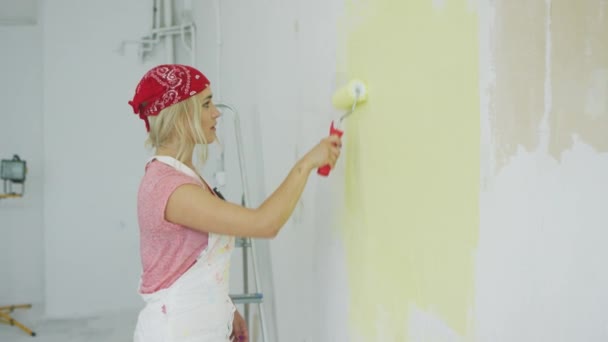 Woman painting wall with roller  - Footage, Video