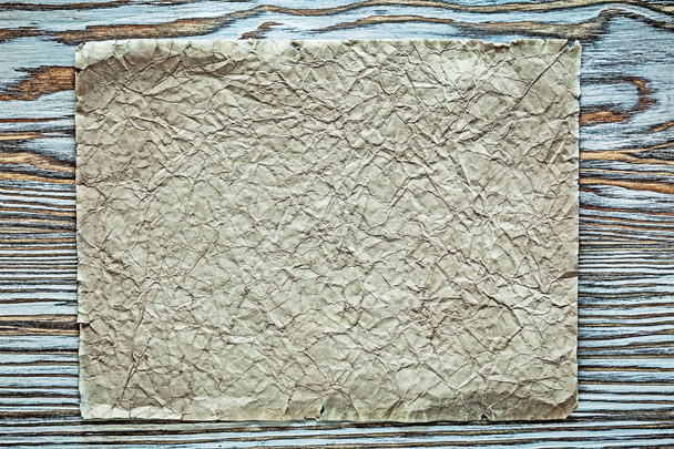 Vintage crumpled paper scroll on wooden board - Fotografie, Obrázek