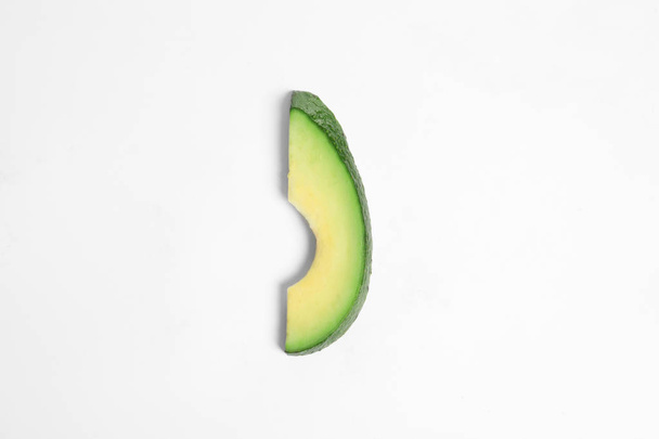 Slice of avocado on white background - Foto, Bild