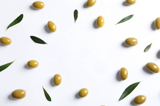 Flat lay composition with fresh olives covered with oil on white background - Foto, immagini