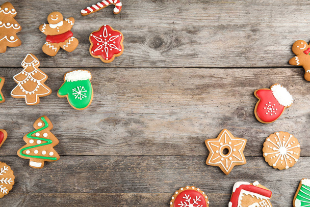 Tasty homemade Christmas cookies on wooden background, top view - Fotó, kép