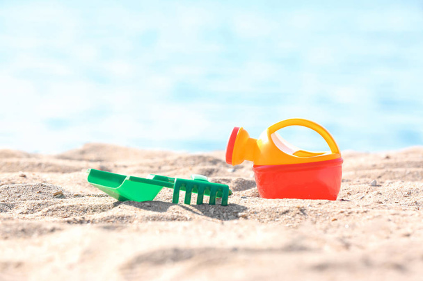 Children toys on sand near sea. Beach object - Foto, Imagen
