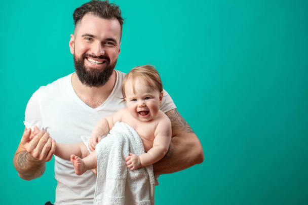 Young father is having fun with his little baby - Foto, afbeelding