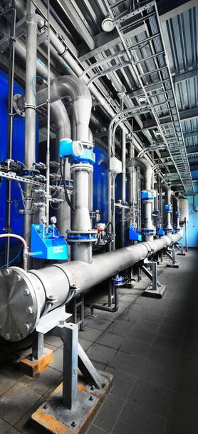 Large industrial water treatment and boiler room. Shiny pipes, pressure vessels, piping armateure - Photo, Image