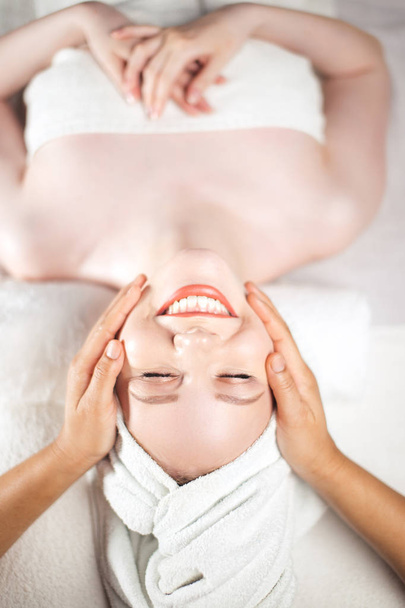 Young attractive woman getting spa treatment over white background - Φωτογραφία, εικόνα