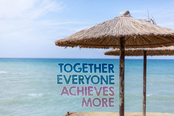Word writing text Together Everyone Achieves More. Business concept for Teamwork Cooperation Attain Acquire Success Blue beach water Thatched Straw Umbrellas Message Ideas Thoughts Reflection - Photo, Image