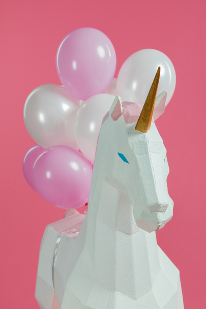 Paper unicorn with decorative air balloons isolated on pink - Fotoğraf, Görsel