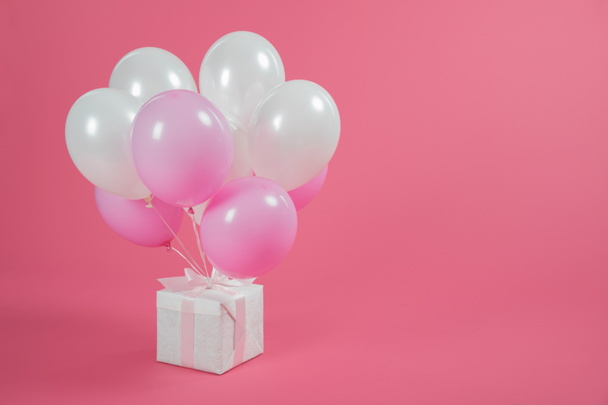 Gift box and balloons on pink background - Photo, Image