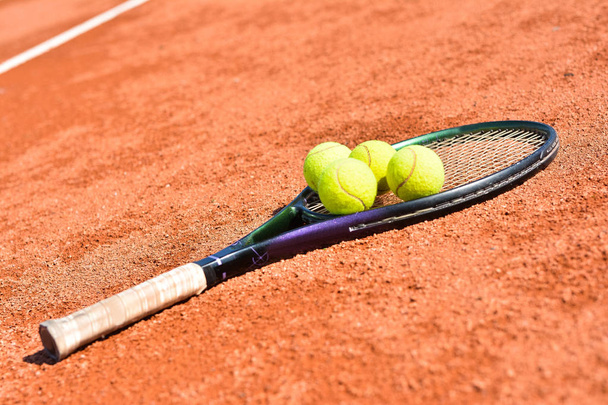 Vista da vicino della racchetta da tennis e delle palline sul campo da tennis in terra battuta
 - Foto, immagini