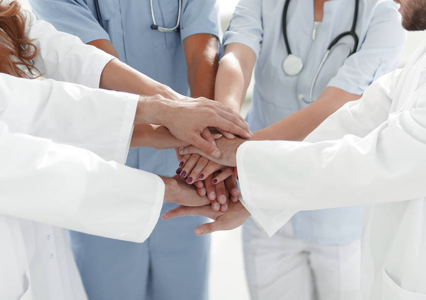 Doctors and nurses stacking hands. concept of mutual aid. - Fotó, kép
