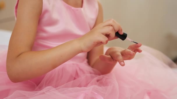 Adorable little girl painting nails, doing hairstyle in bedroom. Party styling concept. - Footage, Video