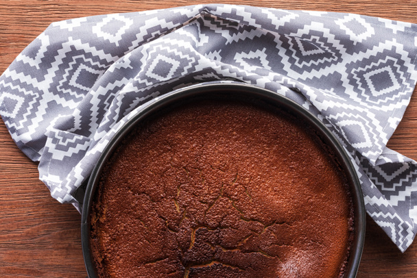 top view of delicious homemade brownie and cloth on wooden table - Fotografie, Obrázek