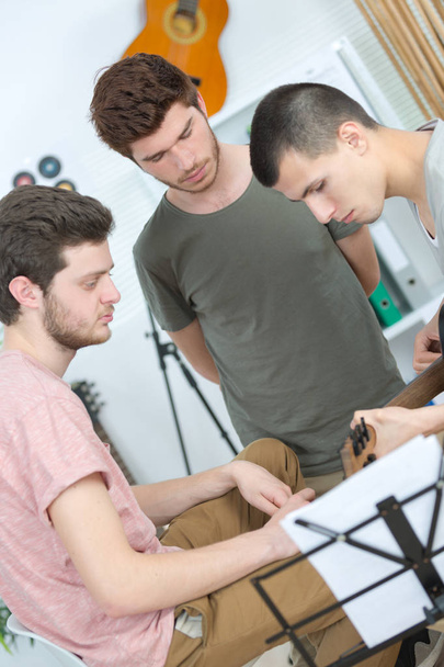 young band music playing a song in a recording studio - Photo, image