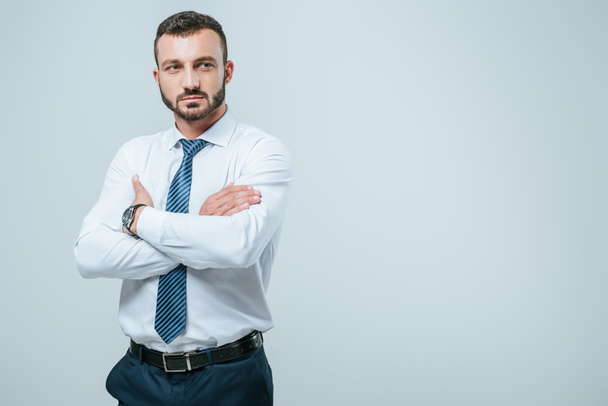 handsome businessman standing with crossed arms isolated on grey - Photo, Image