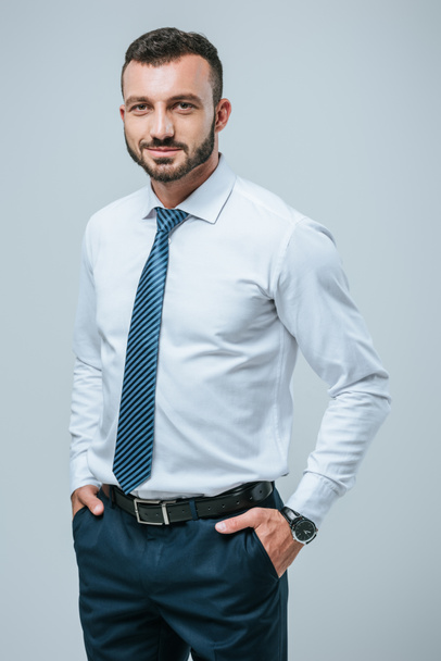 handsome cheerful businessman posing isolated on grey - Photo, image