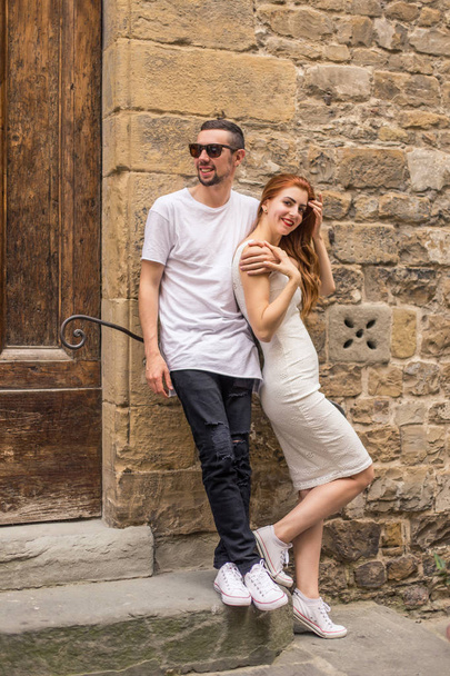 Young happy couple posing near wall on old european street - Photo, Image