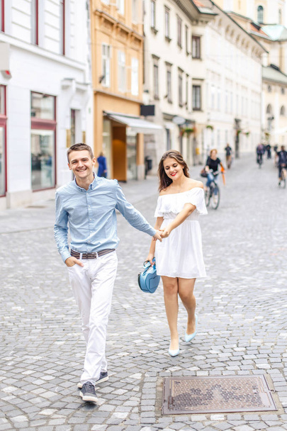 Happy young couple walking on pedestrian street of Ljubljana, Slovenia - Zdjęcie, obraz