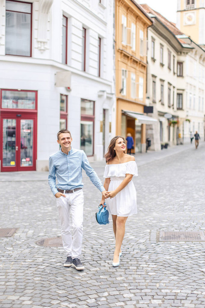 Happy young couple walking on pedestrian street of Ljubljana, Slovenia - Fotoğraf, Görsel