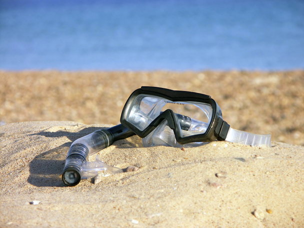Tube and mask for a scuba diving on seacoast with sand - Фото, зображення