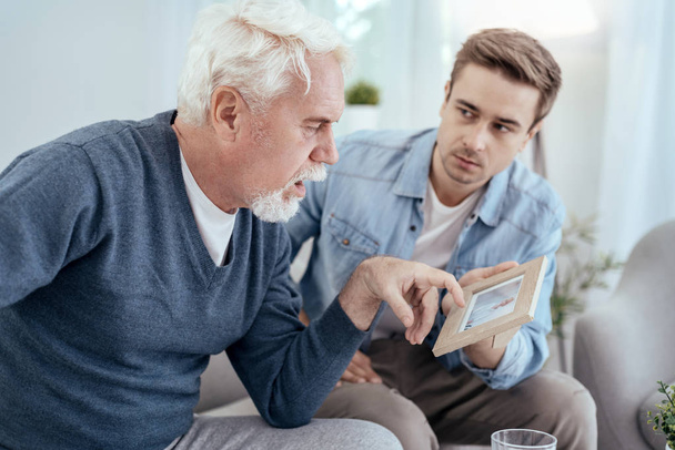 Appealing senior man memorizing relatives - Zdjęcie, obraz
