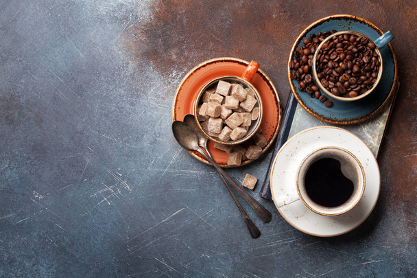 Coffee cups, beans and brown sugar. Top view with space for your text - Photo, Image