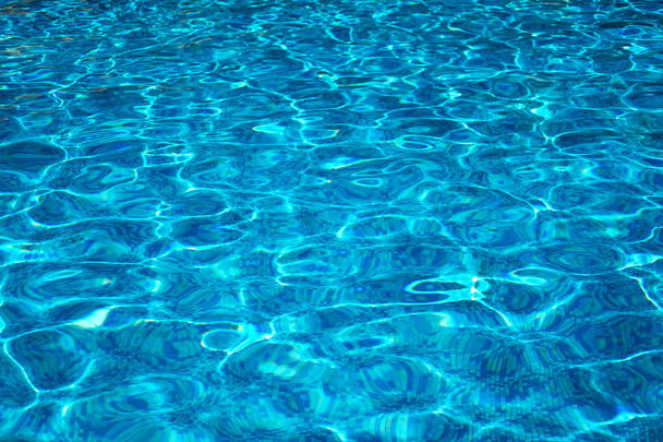 Pure pool water background with sun ray lights on it. - Photo, Image