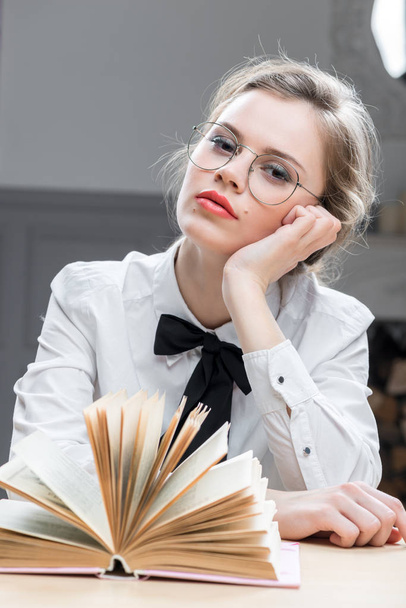 portrait of a dreamy girl with glasses with a book - Fotografie, Obrázek