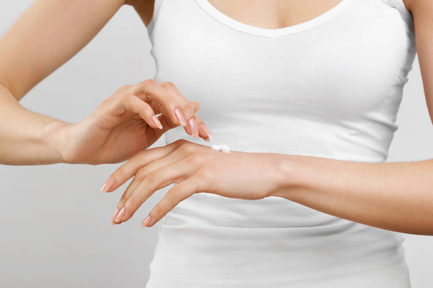 beautiful woman hands with cream.woman hands applying moisturizing cream to her skin - Photo, Image