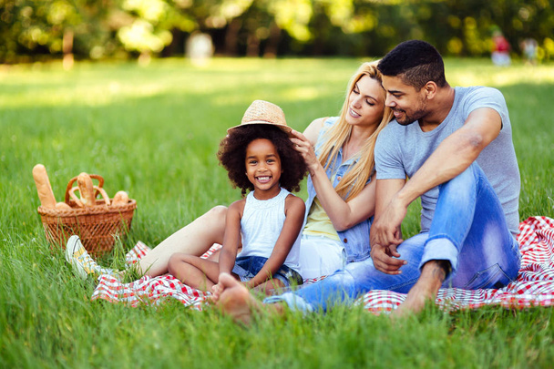 Picture of lovely couple with their daughter having picnic in nature - Valokuva, kuva
