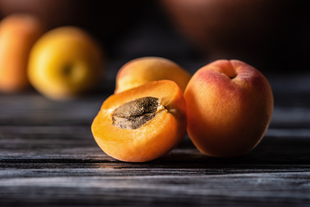 selective focus of ripe apricots on wooden table - Φωτογραφία, εικόνα