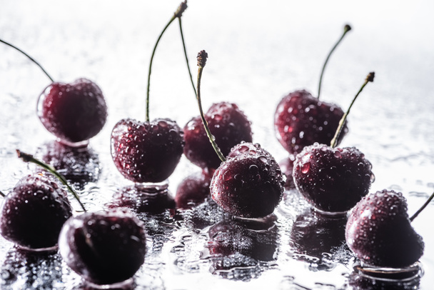 red ripe cherries with water drops on wet surface  - Photo, Image
