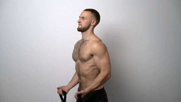 Entrenamiento muscular sin camisa con banda de resistencia
 - Imágenes, Vídeo