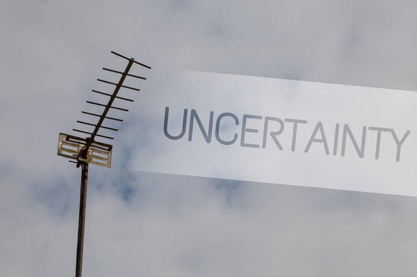 Writing note showing Uncertainty. Business photo showcasing Unpredictability of certain situations events behavior Sky cloud cloudy grey gloomy tall big antenna nature rainy day weather - Photo, Image