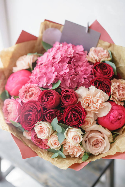 beautiful spring bouquet. flower arrangement with hydrangea and peonies. Color red and pink. The concept of a flower shop, a small family business - Zdjęcie, obraz