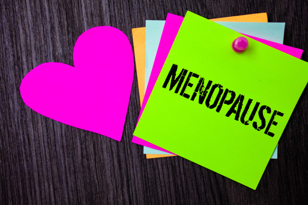 Conceptual hand writing showing Menopause. Business photo text Cessation of menstruation Older women hormonal changes period Pinned multi colour cards heart polish dark lining background - Photo, Image