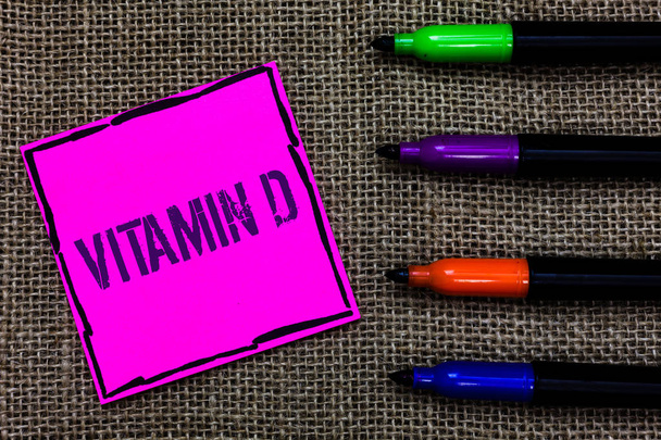 Writing note showing Vitamin D. Business photo showcasing Benefits of sunbeam exposure and certain fat soluble nutriments Marker pens art pink paper nice mat love thought black shadow memories - Photo, Image
