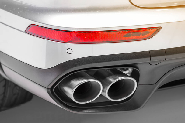 Close up of double chrome exhaust pipe of a white powerful modern sport car.  - Foto, Bild