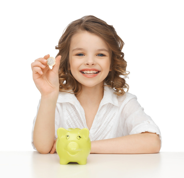 Girl with piggy bank - Фото, изображение