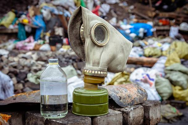 Respirator mask for gas on the background of trash. - Photo, Image