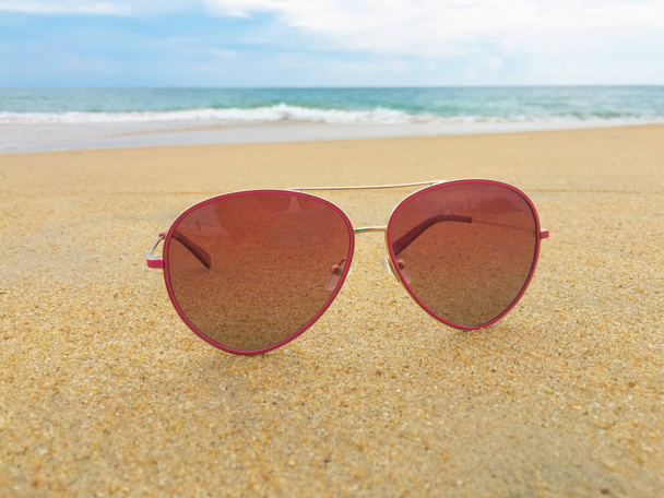 sea landscape reflecting in the sunglasses on the beach  - Photo, Image