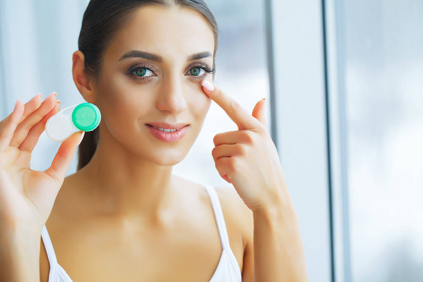 Health. Young Girl Holds Contact Lens In Hands. Portrait of a Beautiful Woman with Green Eyes and Contact Lenses. Healthy Look. High Resolution - Photo, Image