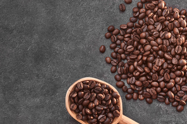 Coffee beans in an old wooden spoon - Фото, зображення