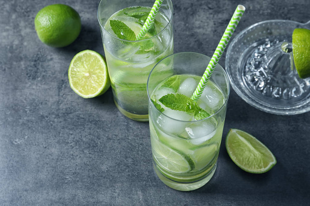Glasses of natural lemonade with lime on table - Photo, Image