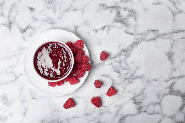 Flat lay composition with delicious raspberry jam on marble background - Foto, immagini