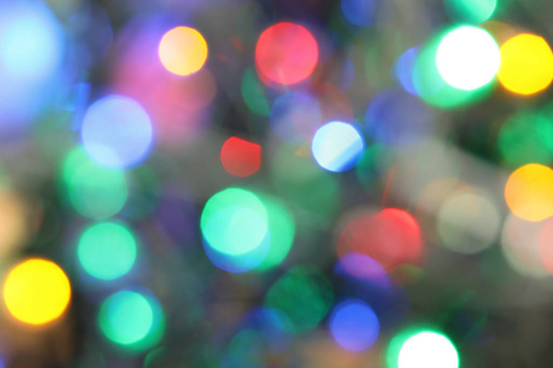 Blurred view of glowing Christmas lights as background - 写真・画像
