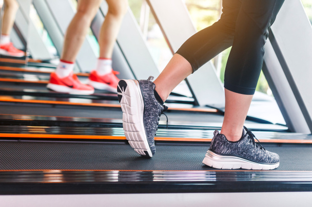 People running on machine treadmill at fitness gym.fitness and lifestyle concept - Valokuva, kuva