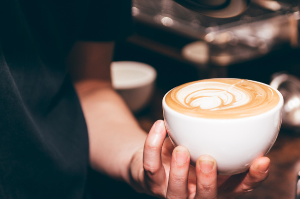Barista holding coffee latte art in coffee shop - Photo, Image