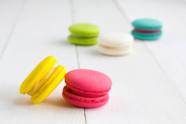 Colorful Macaroons on white wooden background. - Fotó, kép