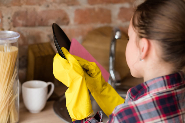 little helper young girl wash dishes yellow gloves - Fotografie, Obrázek